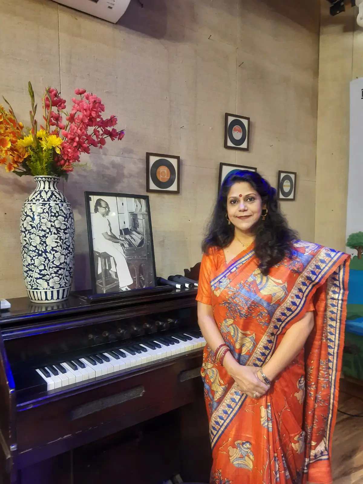 Smt Antara Chowdhury in front of the famous organ once played by her father at Hindusthan Records.